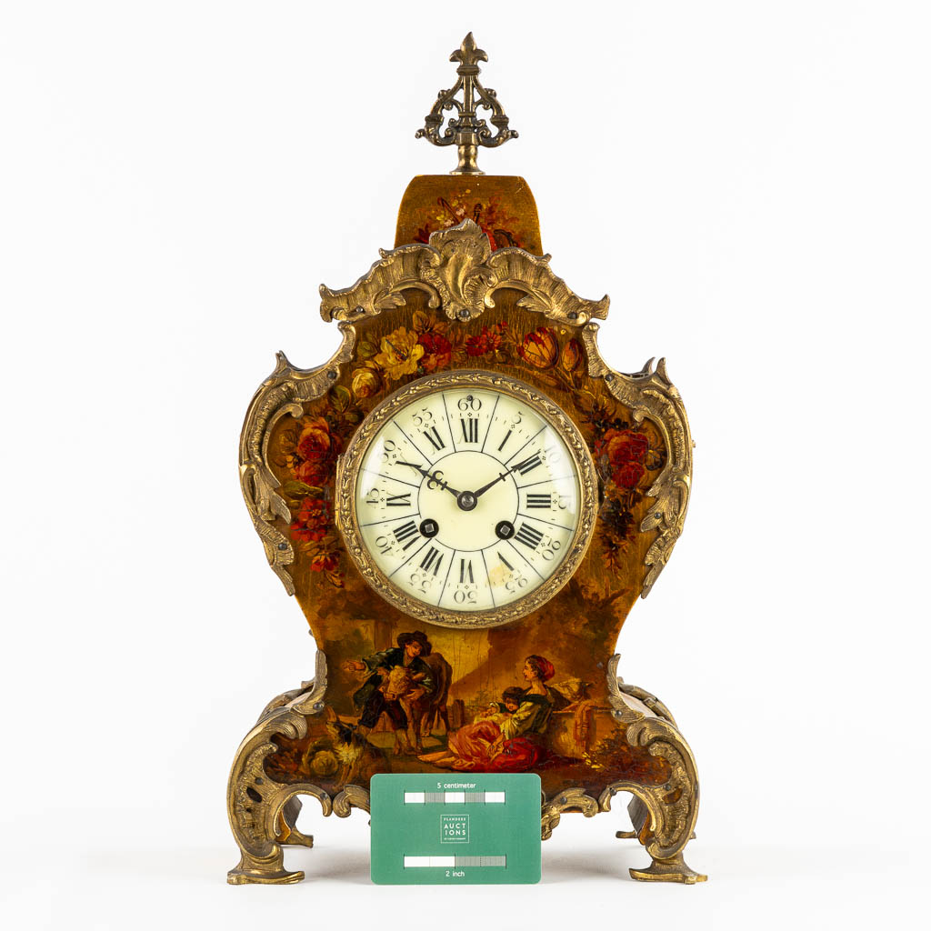 A cartel clock, hand-painted floral decor, mounted with bronze. (c.1900). 