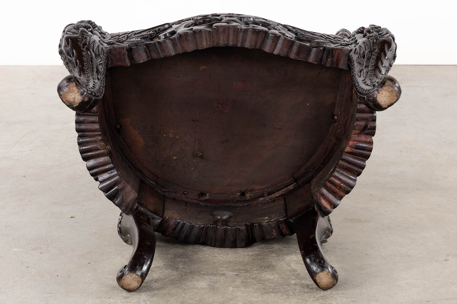 A Chinese sculptured hardwood armchair with a dragon decor. 