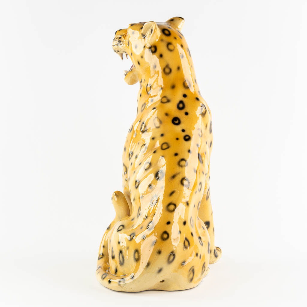 A large glazed faience Leopard, Italy, 20th C. (L:33 x W:46 x H:73 cm)