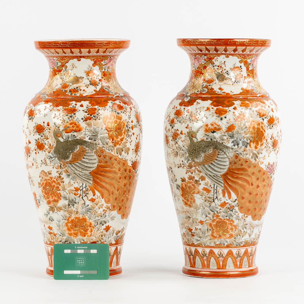 A pair of Japanese Kutani vases, richly finished with a peacock decor. (H:37 x D:19 cm)