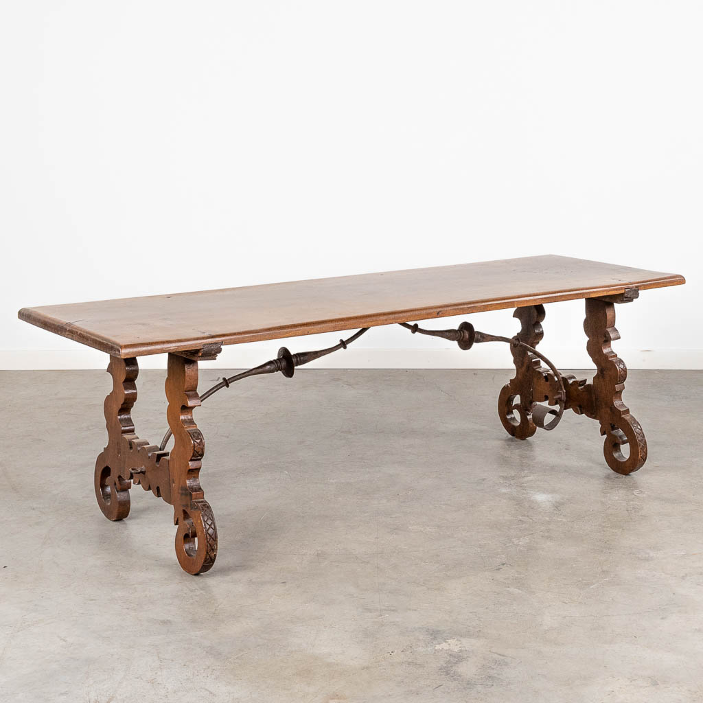 A coffee table, made of walnut in Spanish style. (L: 157 x W: 52 x H: 52 cm)