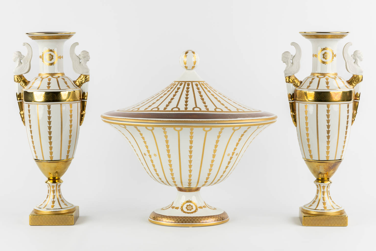 Mangani, Italy, a three-piece garniture, gilt porcelain in Empire style. (L:32 x W:43 x H:40 cm)