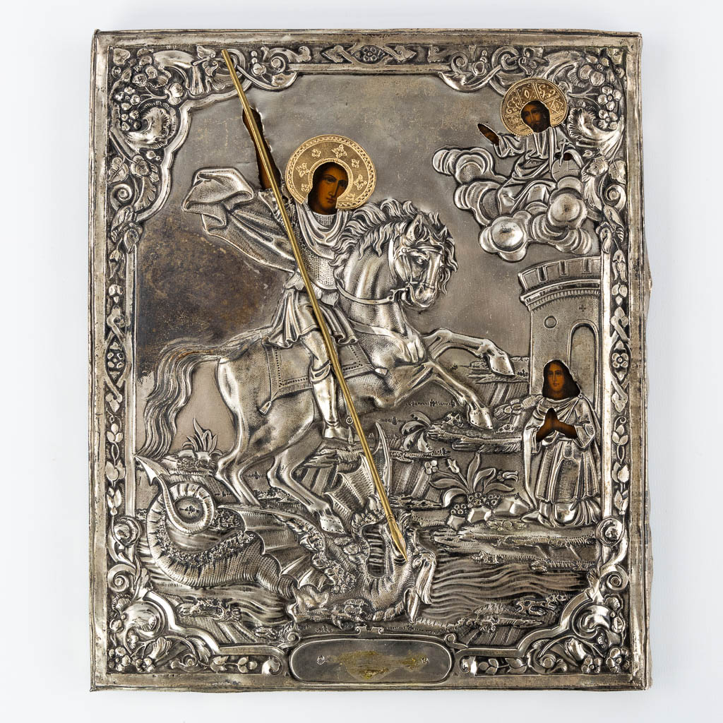 An antique Russian icon with a silver rizza 'Saint George and the Dragon', 1865. (W:26 x H:31 cm)