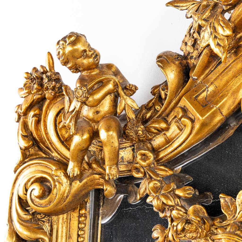 A mirror, sculptured wood, and stucco in a Louis XV style. 20th C. (W:110 x H:218 cm)