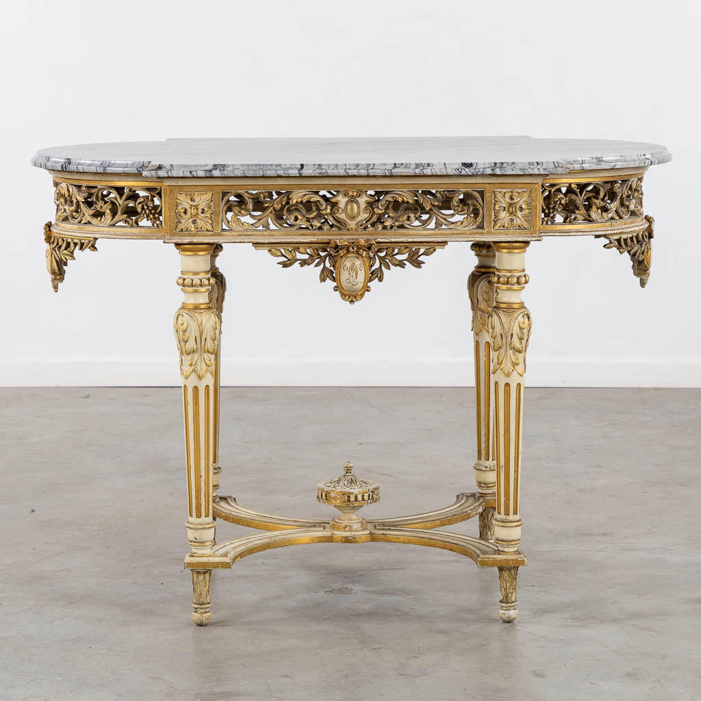 A wood-sculptured and patinated table with a grey marble, Louis XVI style. (L:65 x W:112 x H:80 cm)