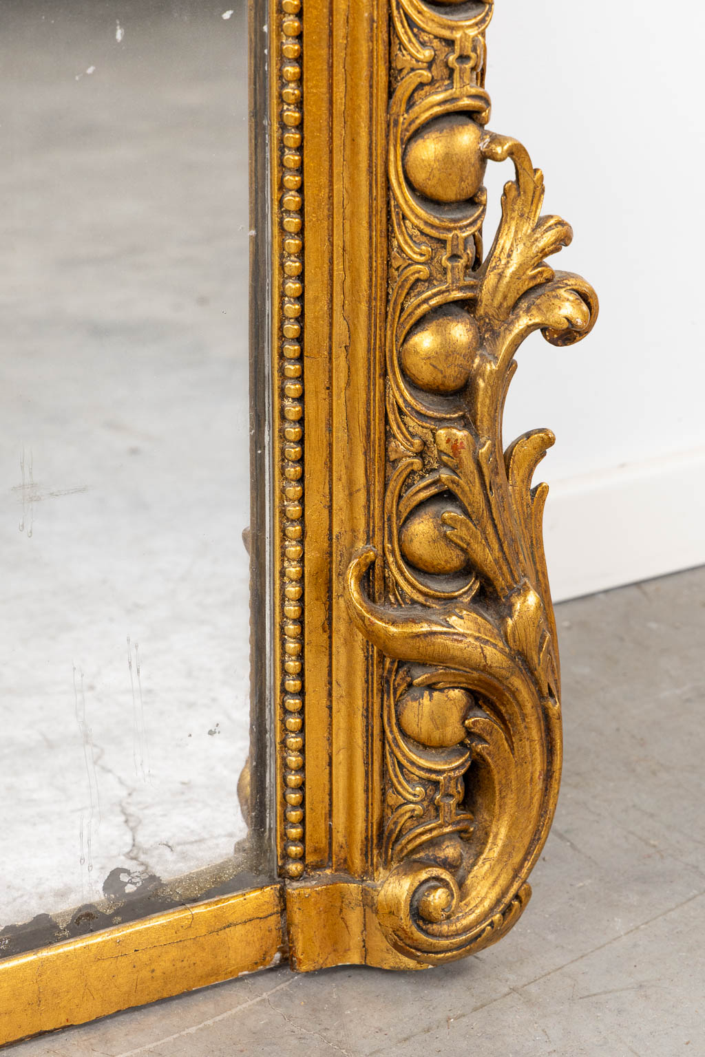 A mirror, sculptured wood, and stucco in a Louis XV style. 20th C. (W:110 x H:218 cm)