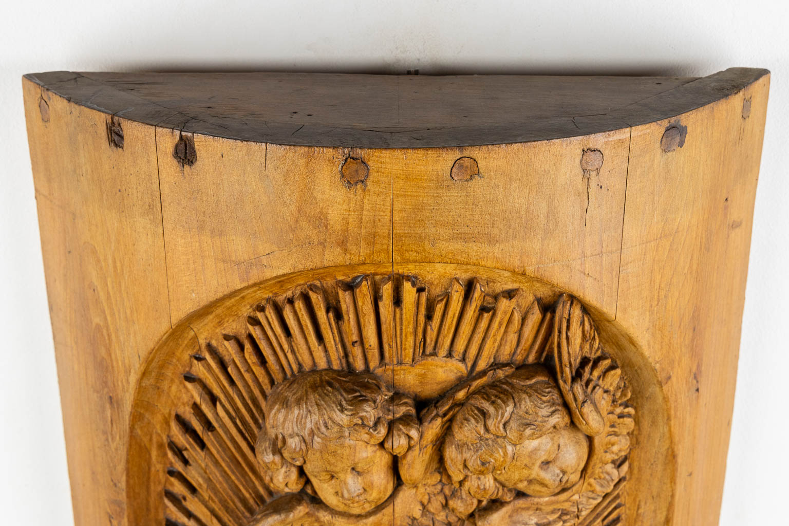 A wood-sculptured tabernacle door, Angels and a Sacred Heart, Baroque style. 