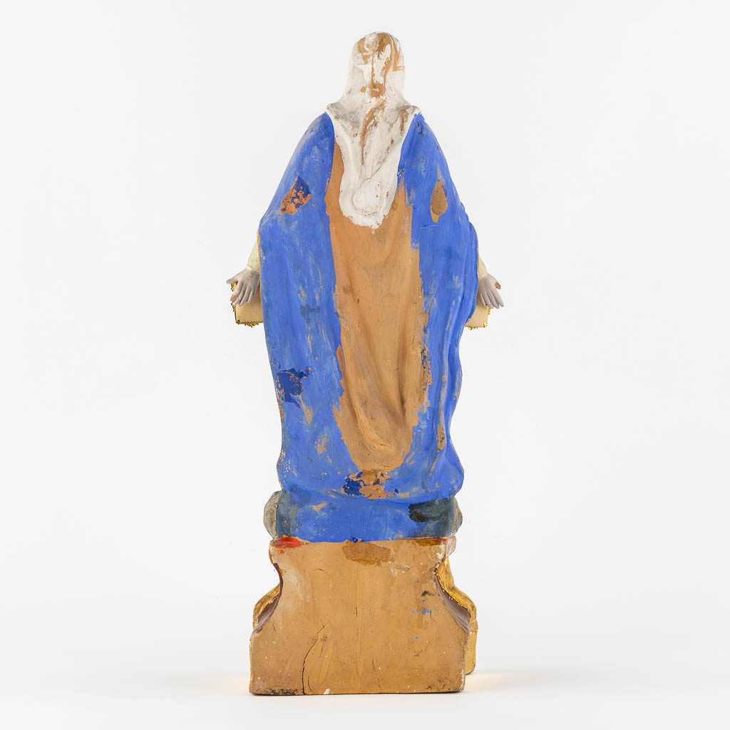 A patinated terracotta figurine of The Virgin Mary. (c1900)