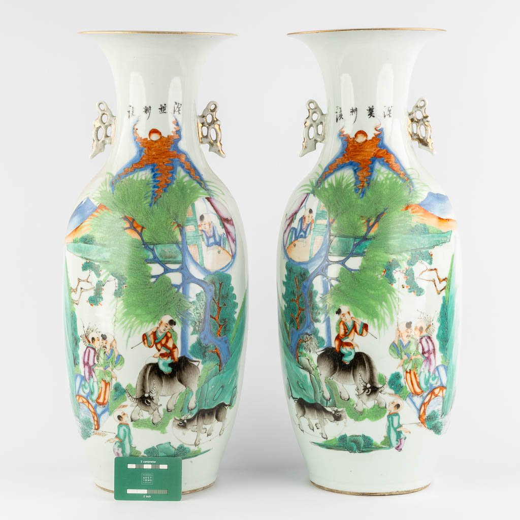 A pair of Chinese vases, decorated with playing children and kaligraphic texts. (H:59 x D:23 cm)