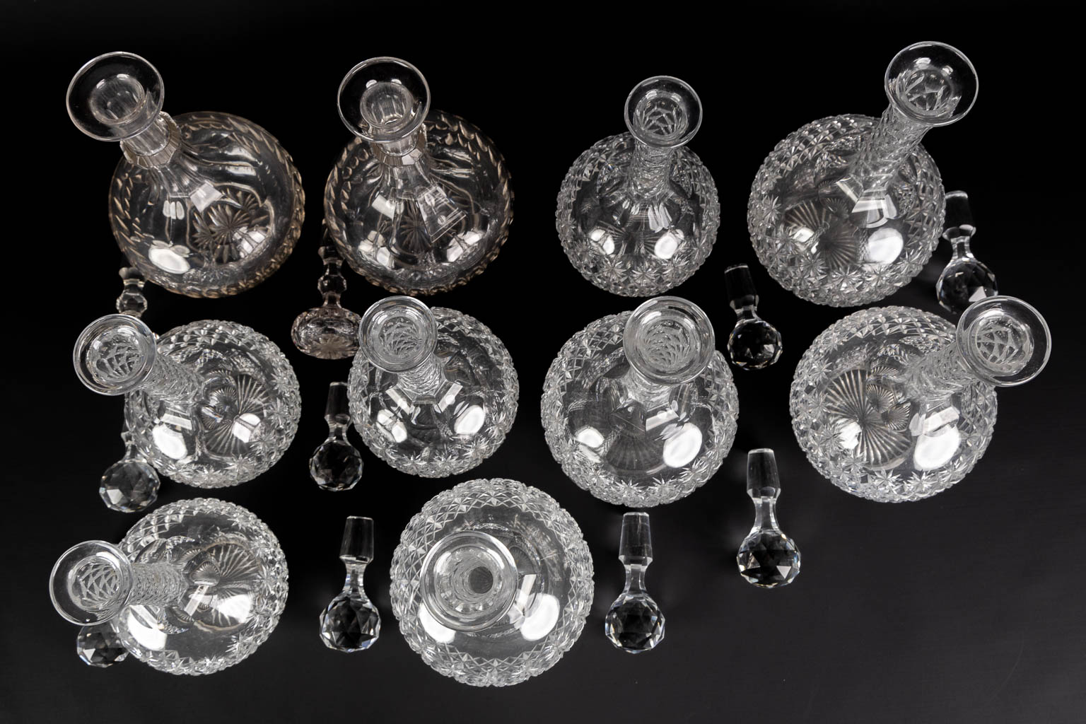 A matching set of 8 caraffes, added are a pair. Cut crystal. (H:34 cm)