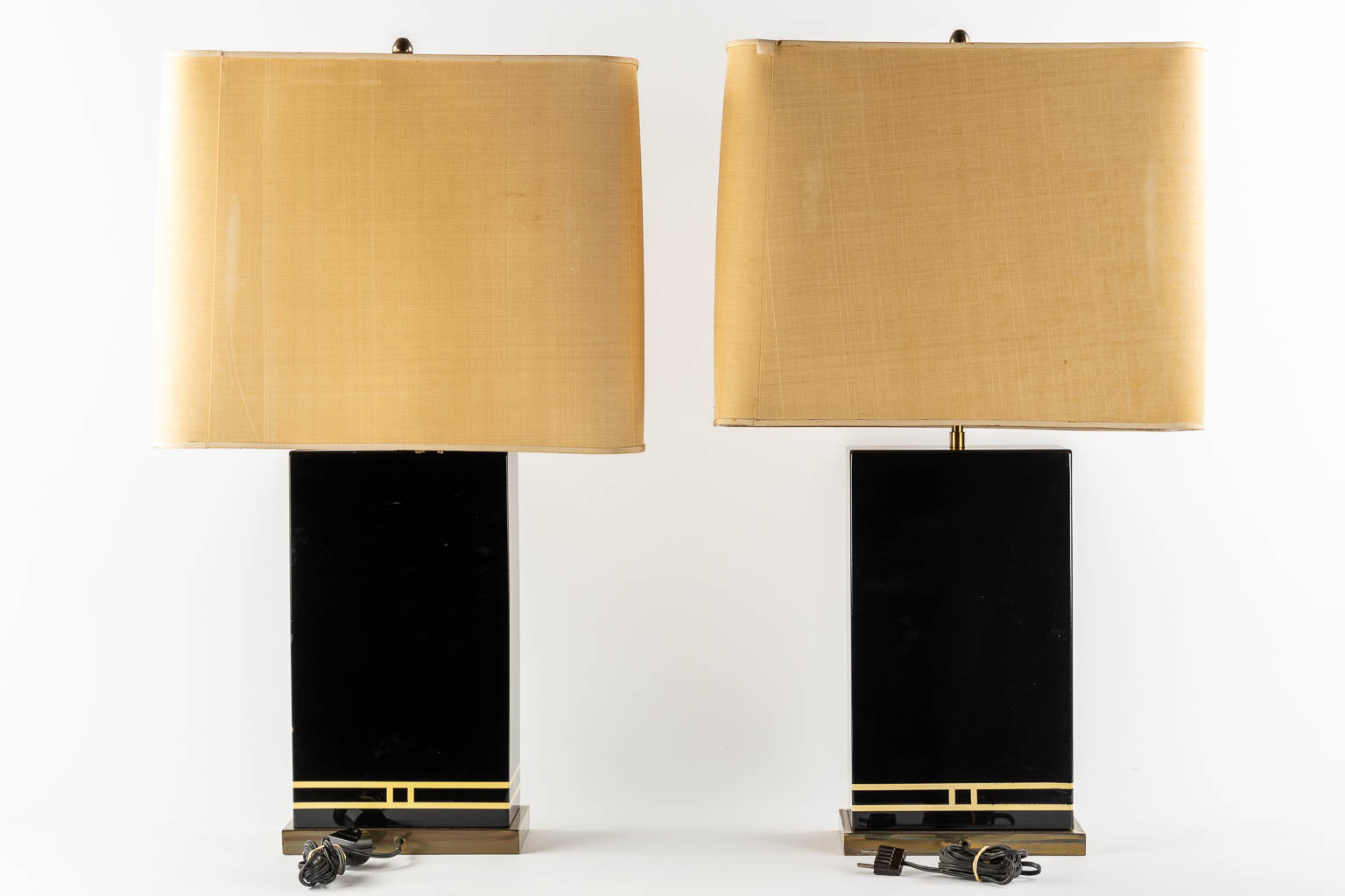 A pair of black-lacqured and brass inlay table lamps, in the style of Maison Jansen. (L:16 x W:24 x H:83 cm)