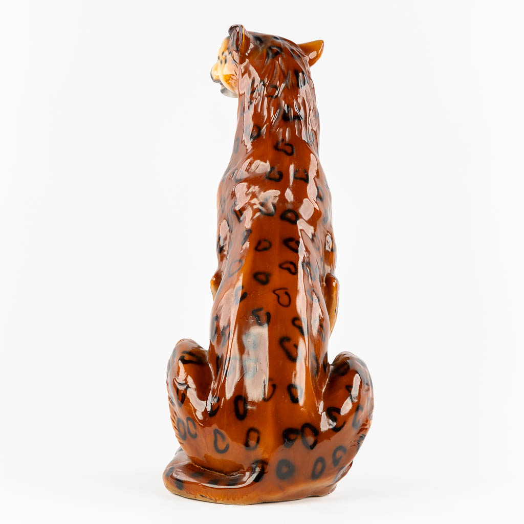 A decorative figurine of a leopard, patinated resine. 