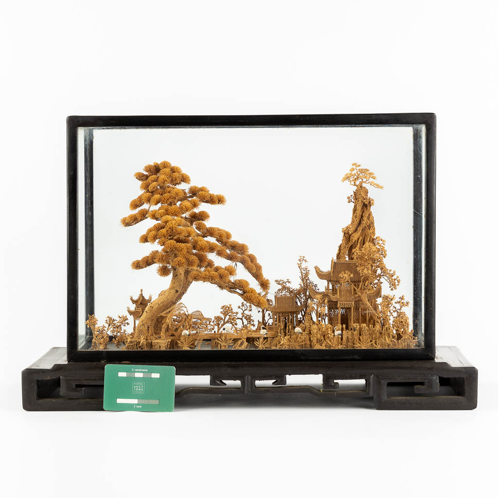 A Japanese cork diorama of a garden, in a glass display cabinet. 20th C. (L:25 x W:55 x H:36 cm)