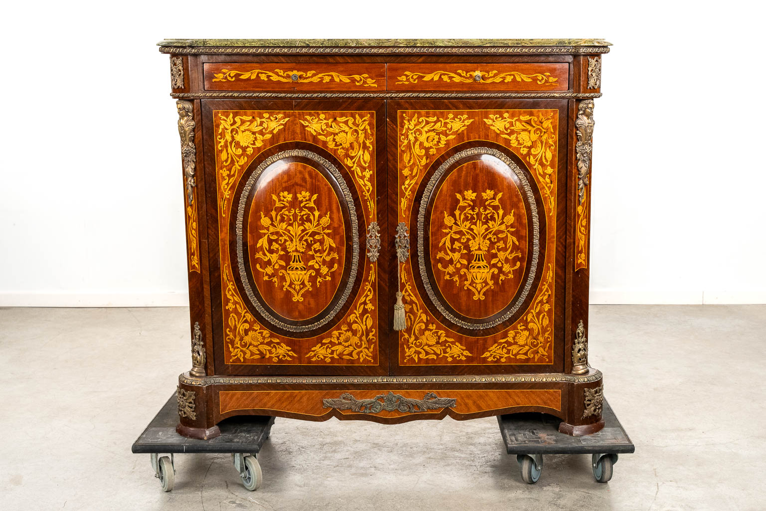 A two-door marquetry inlay cabinet, mounted with bronze and a marble. 20th C.