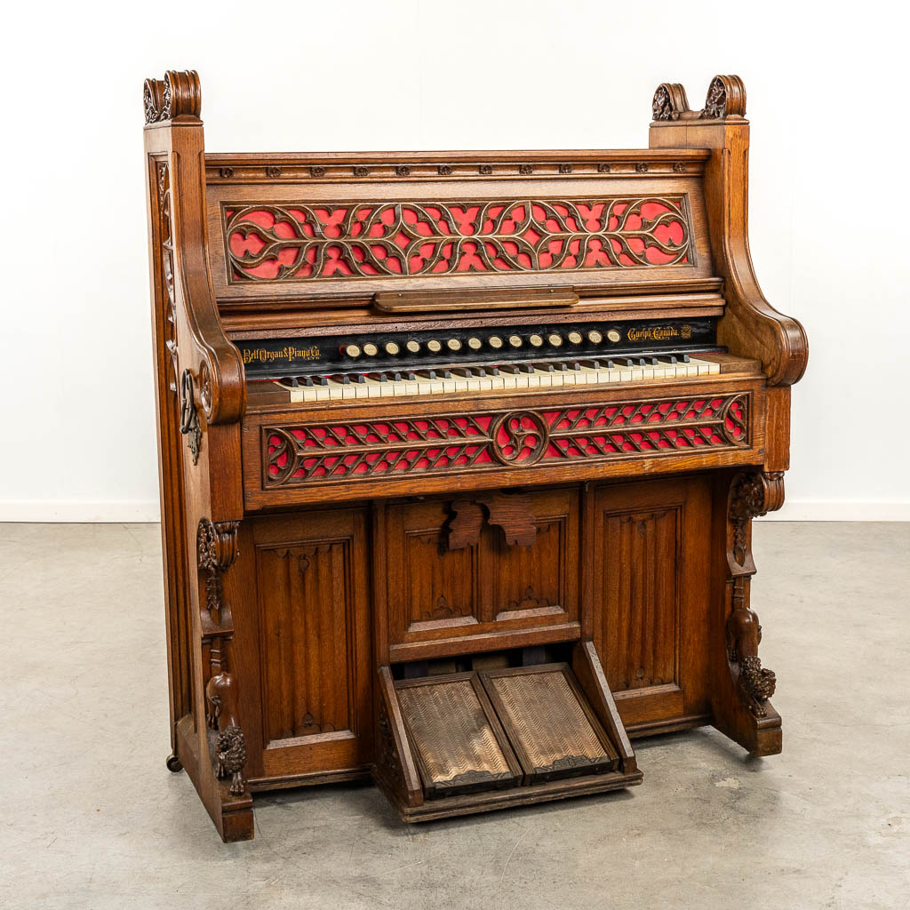 An antique organ, sculptured wood in Gothic Revival style. Circa 1900.