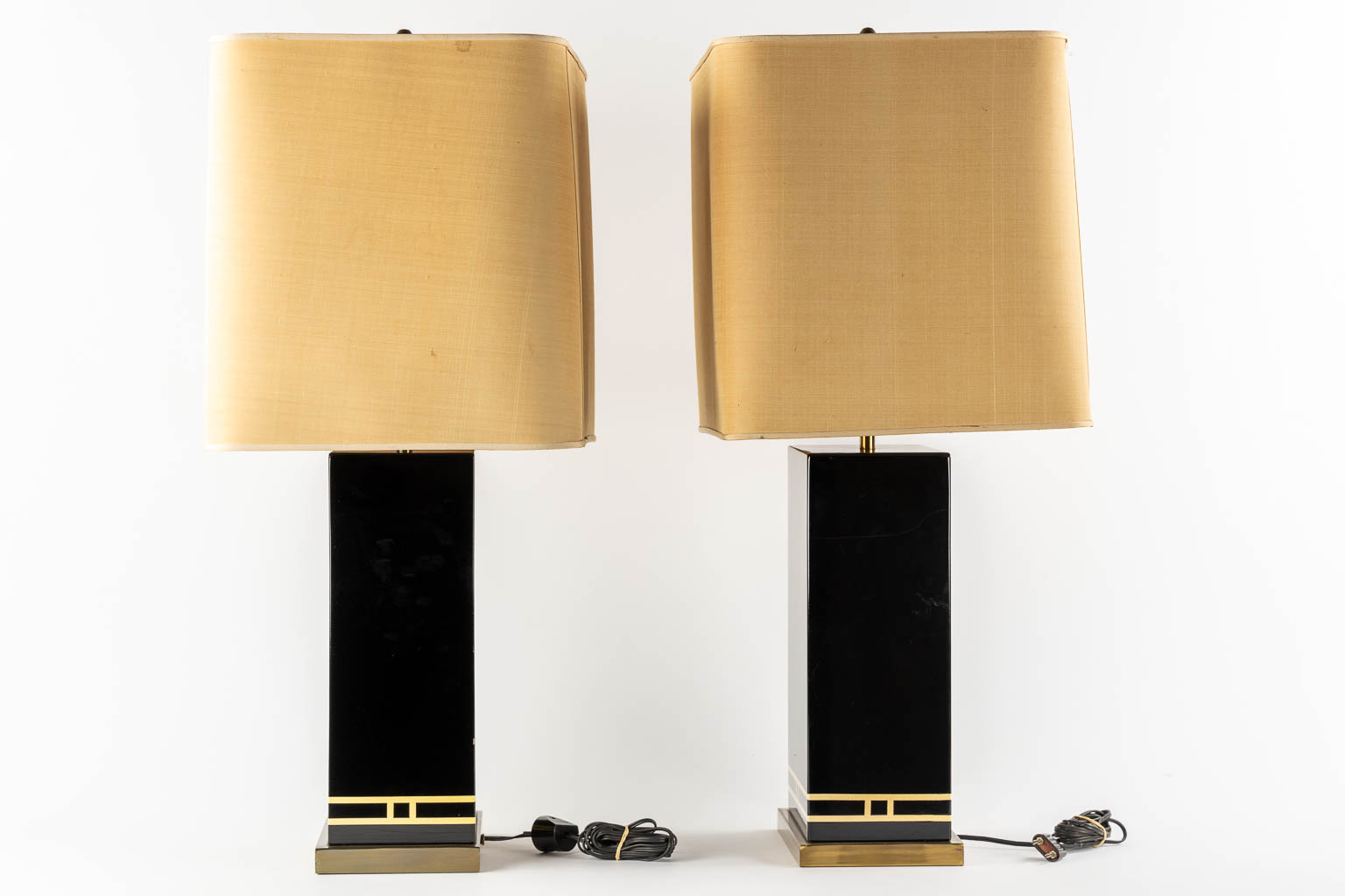 A pair of black-lacqured and brass inlay table lamps, in the style of Maison Jansen. (L:16 x W:24 x H:83 cm)