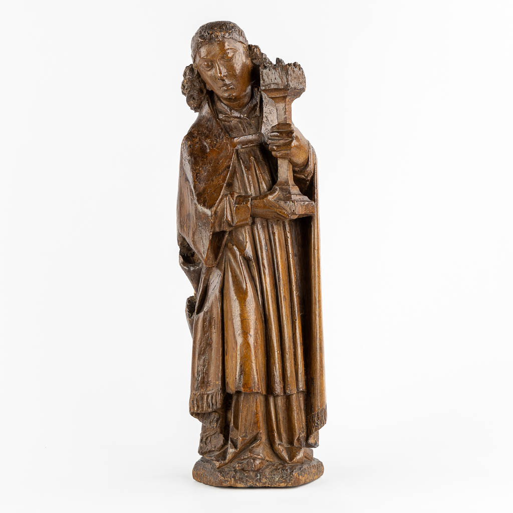 A wood-sculptured 'Angel with a Large Candlestick', Flanders, Late 15th C. (L:14 x W:17,5 x H:56 cm)