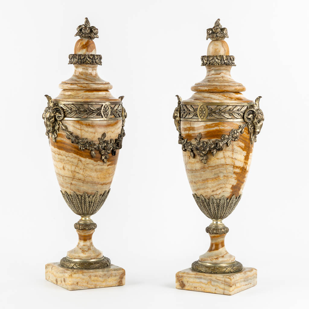 A pair of bronze mounted marble cassolettes with Ram's heads. Circa 1900. (L:17 x W:22 x H:59 cm)