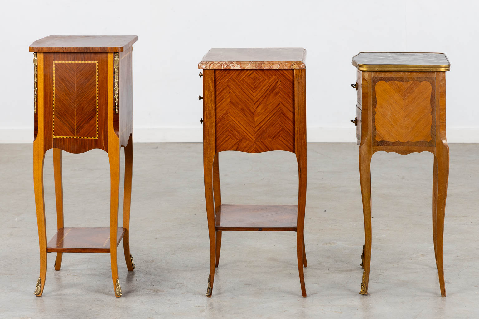 Three side tables, marquetry inlay. Two with a marble top. Circa 1980. (L:33 x W:42 x H:70 cm)