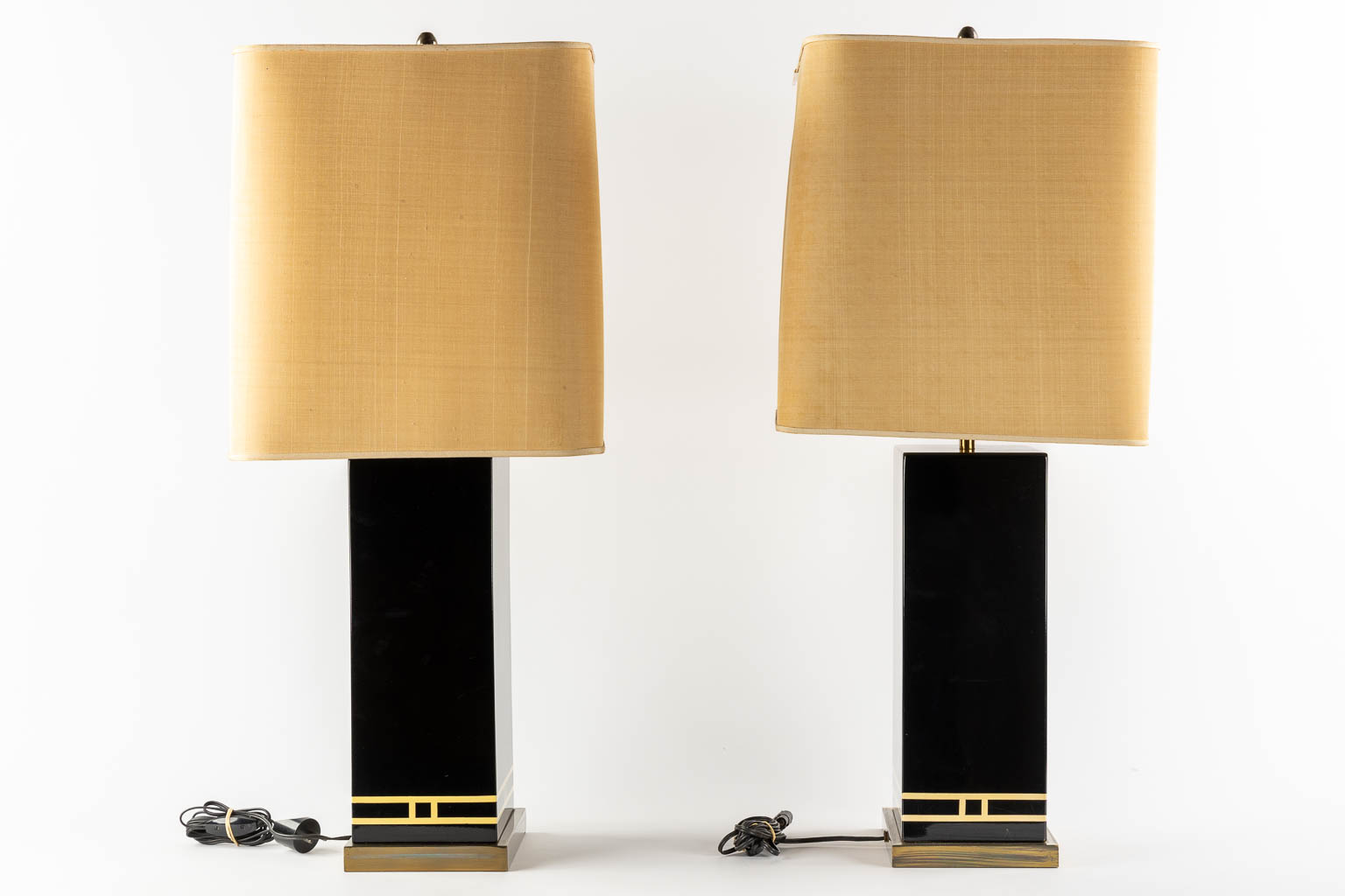 A pair of black-lacqured and brass inlay table lamps, in the style of Maison Jansen. (L:16 x W:24 x H:83 cm)