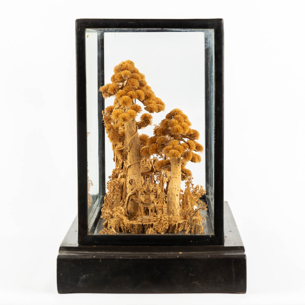 A Japanese cork diorama of a garden, in a glass display cabinet. 20th C. (L:25 x W:55 x H:36 cm)