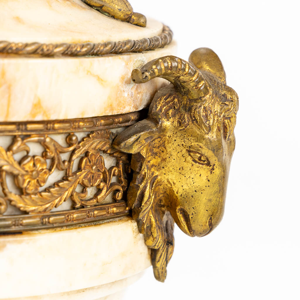 A pair of marble cassolettes, marble mounted with bronze in Louis XVI style. Ram