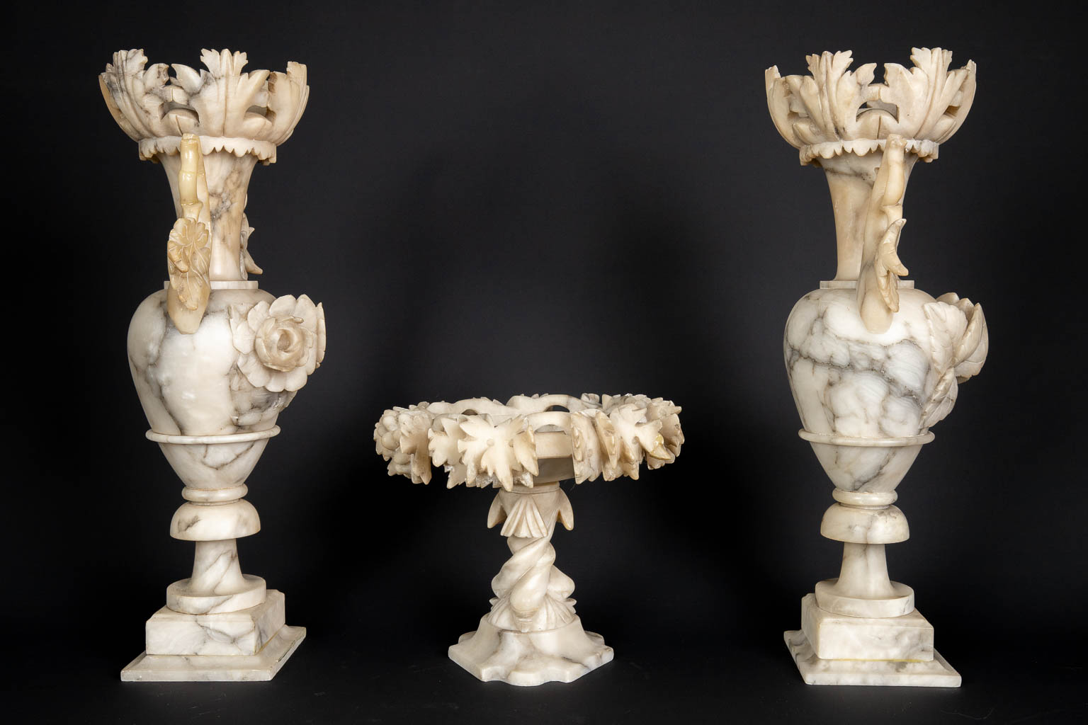 A three piece mantle garniture set, sculptured alabaster. (H:45 x D:15 cm)