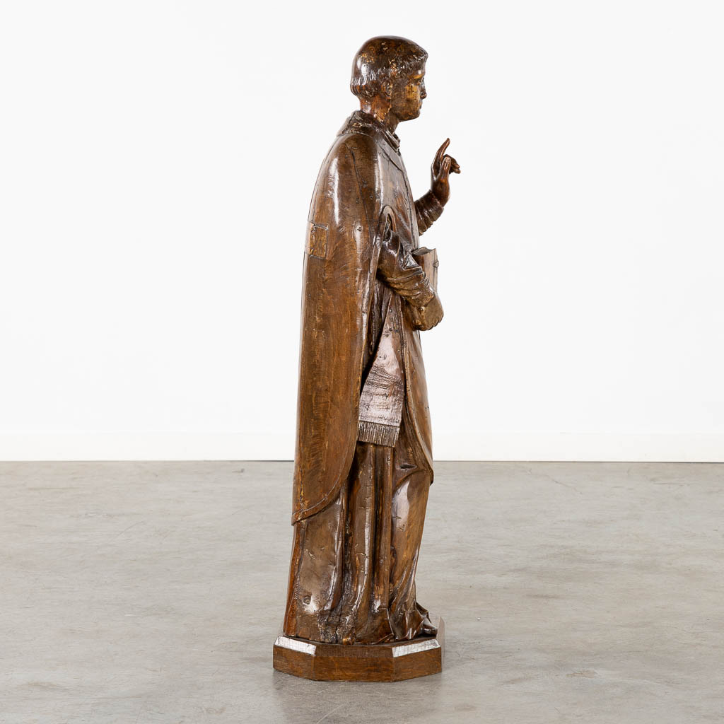 An antique wood-sculptured figurine of Saint Lawrence, 18th/19th C. (L:27 x W:33 x H:106 cm)