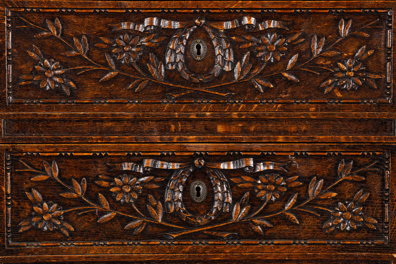 A three-drawer commode, floral wood-sculptures in a Louis XVI style. (L:60 x W:110 x H:99 cm)