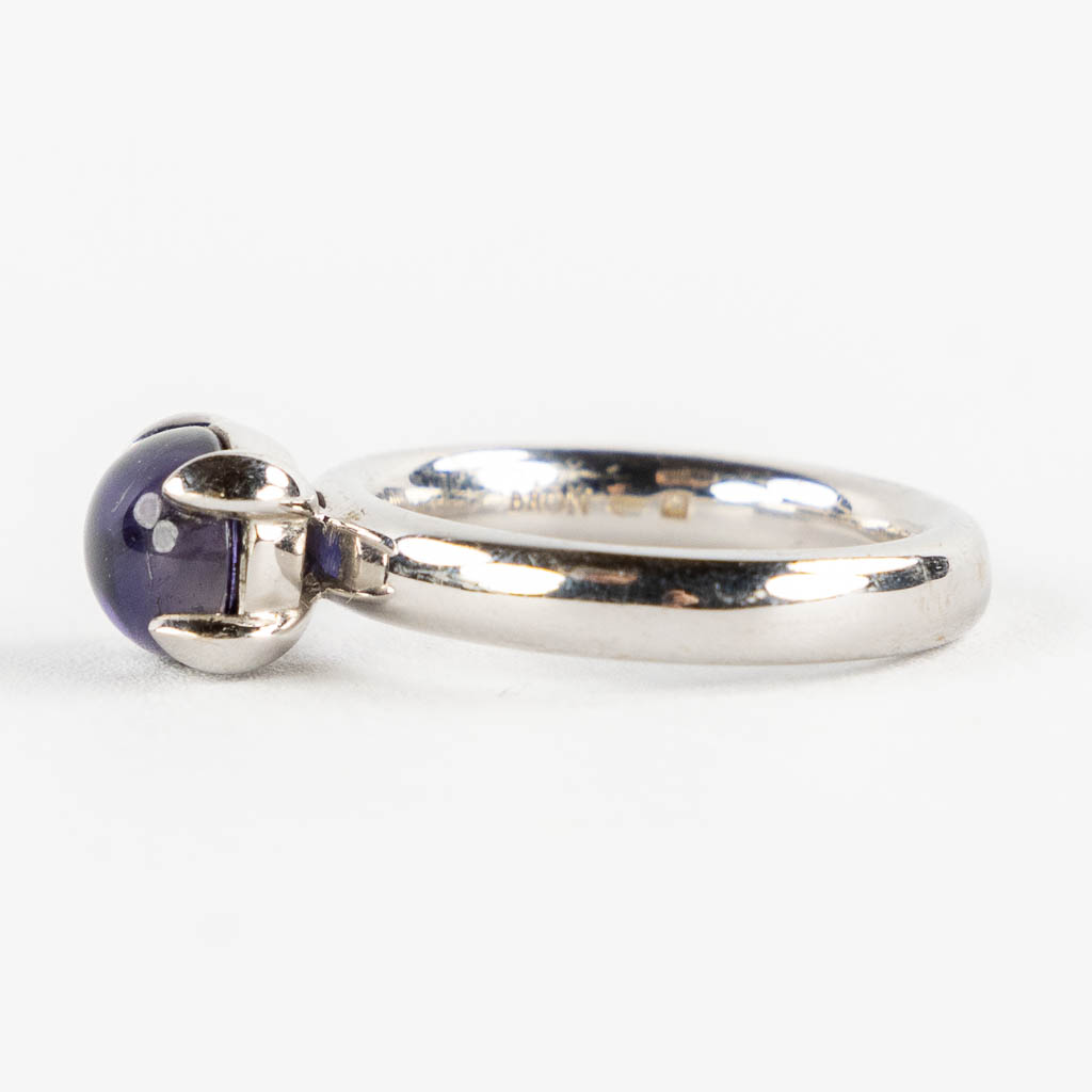 Bron Jewellery, een 18kt wit-gouden ring met cabochon saffier. 11,16g. Ringmaat 57. 