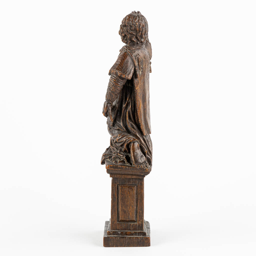 An antique wood-sculptured figurine of a saint holding a scourge. 17th C. (W:10 x H:29 cm)