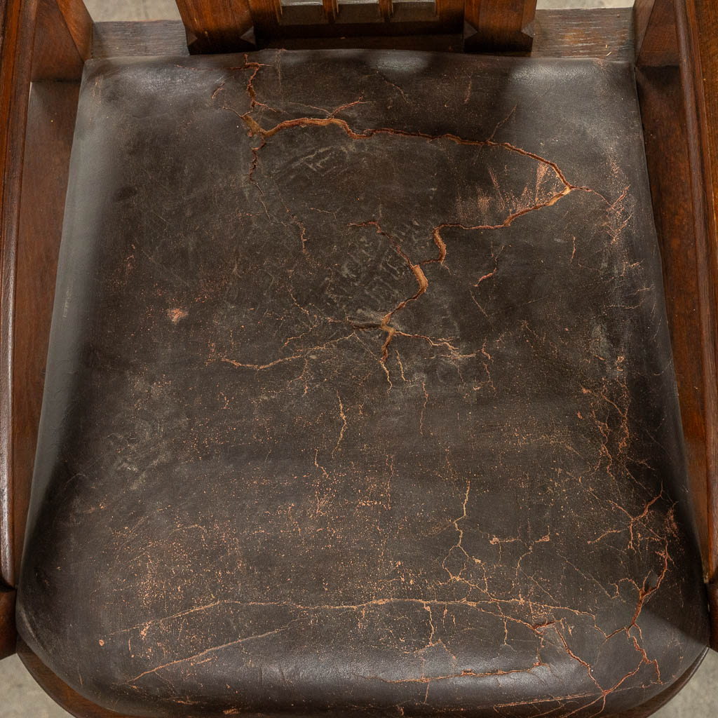 A pair of sculptured wood armchairs and footstool, used in an Art Deco chapel, leather seat. (L:60 x W:60 x H:73 cm)