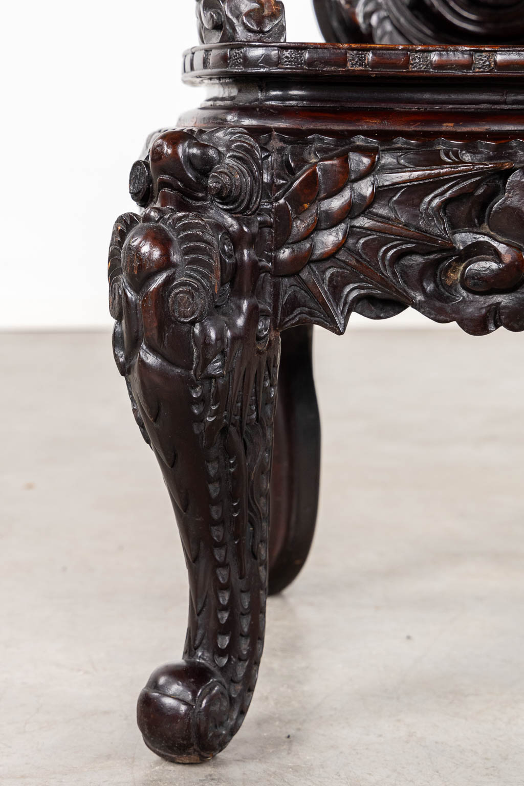 A Chinese sculptured hardwood armchair with a dragon decor. 