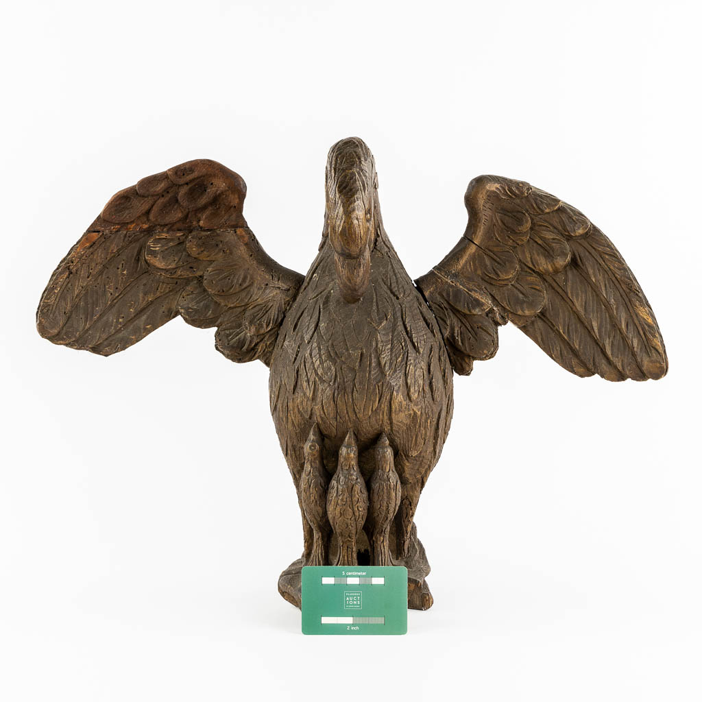 An antique wood-sculptured 'Pelican With Chicks'. 18th/19th C.