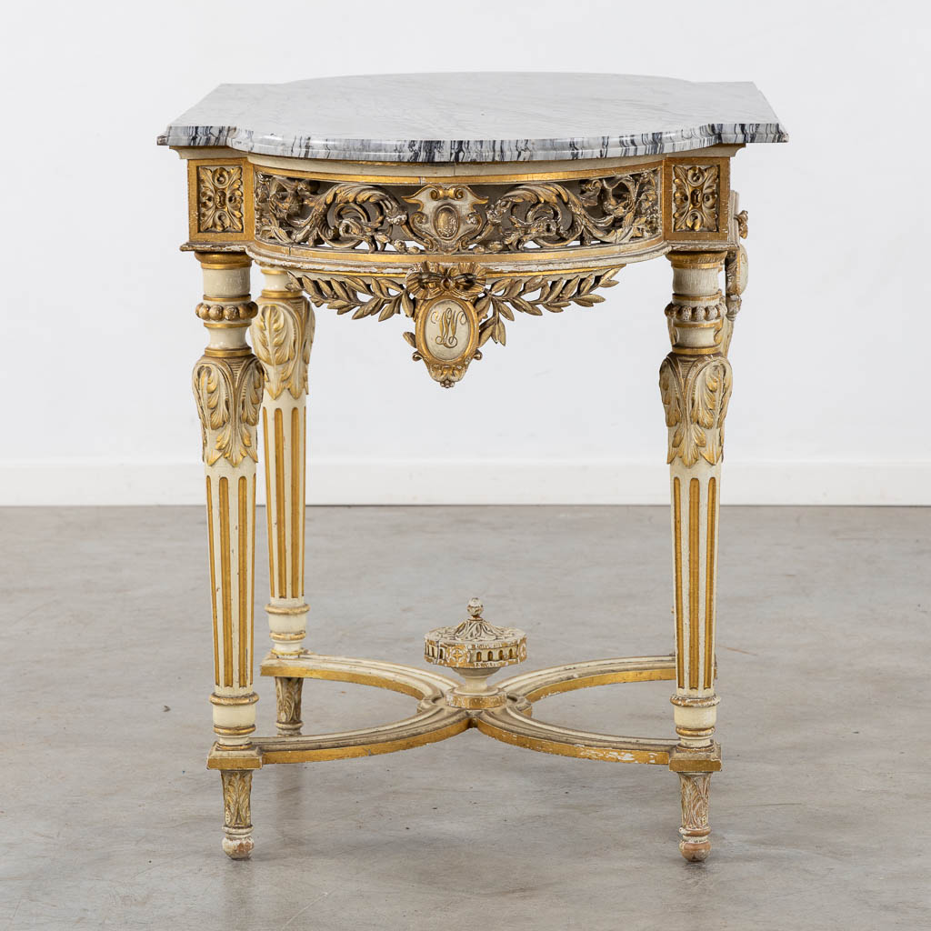 A wood-sculptured and patinated table with a grey marble, Louis XVI style. (L:65 x W:112 x H:80 cm)