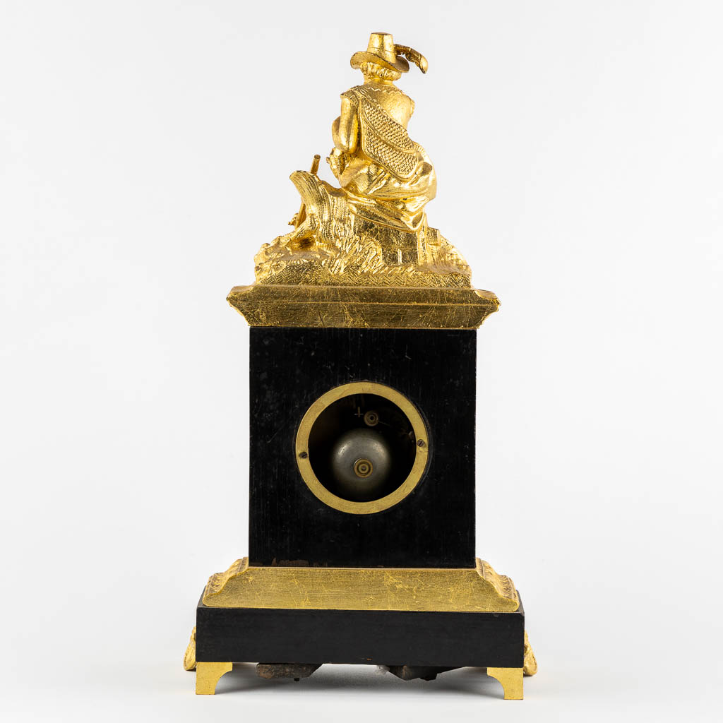 A mantle clock with a 'Hunter', gilt spelter mounted on ebonised wood. 19th C.