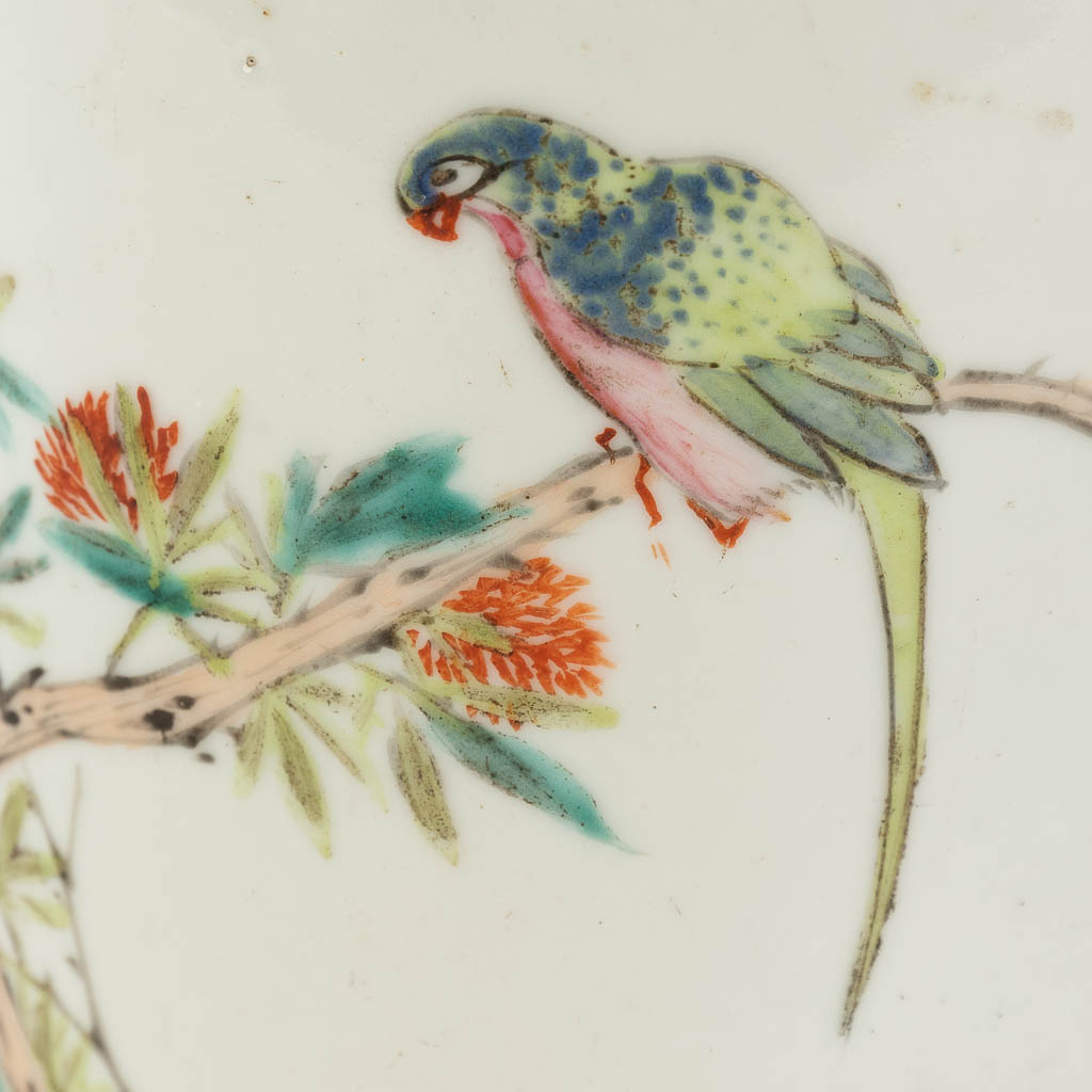 A Chinese brush pot, decorated with branches and a parrot. 19th/20th C. (H: 13,5 x D: 12,5 cm)