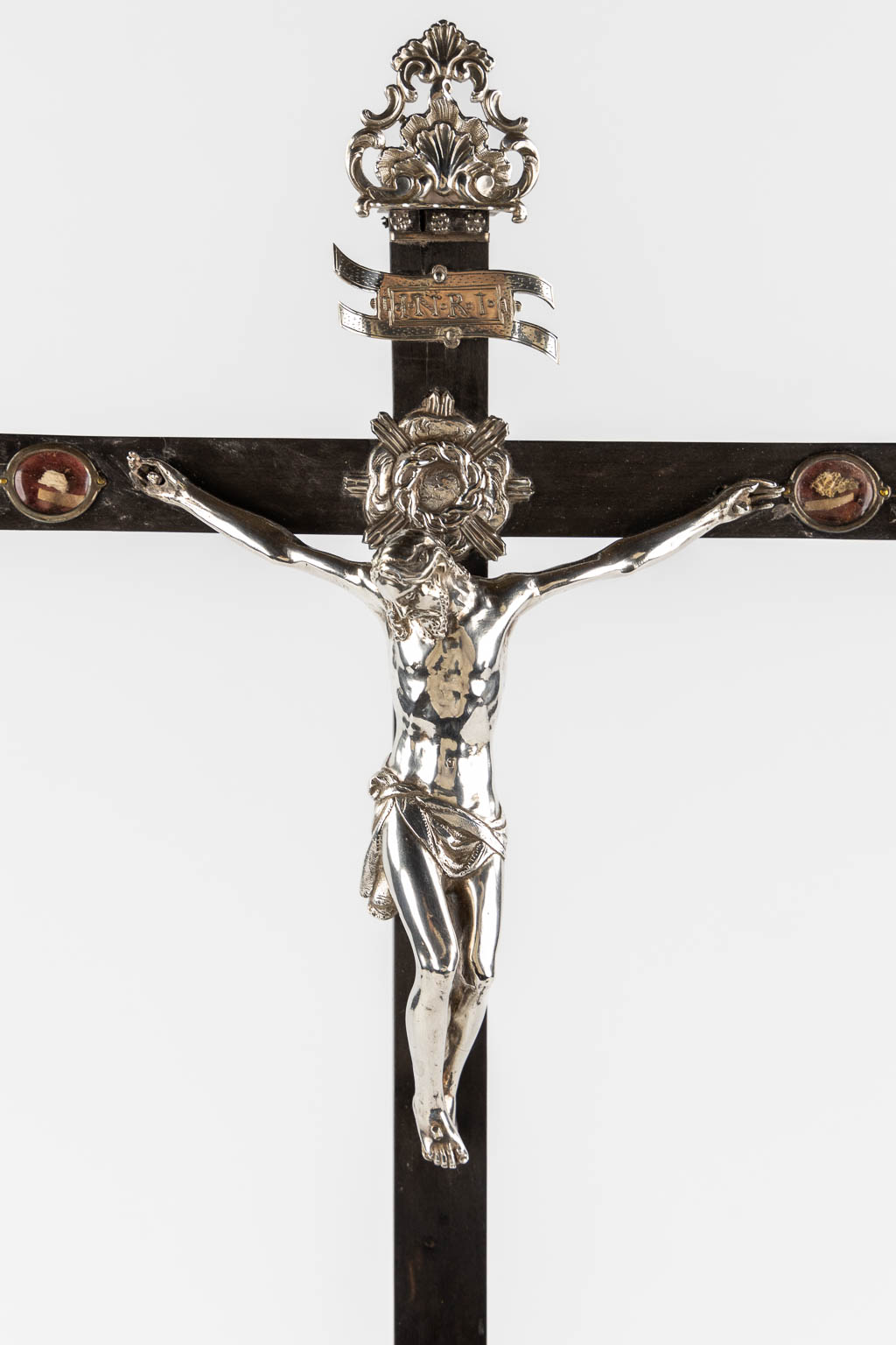 A large reliquary crucifix with 9 relics and an Agnus Dei, ebonised wood and silver-plated metal. 19th C.