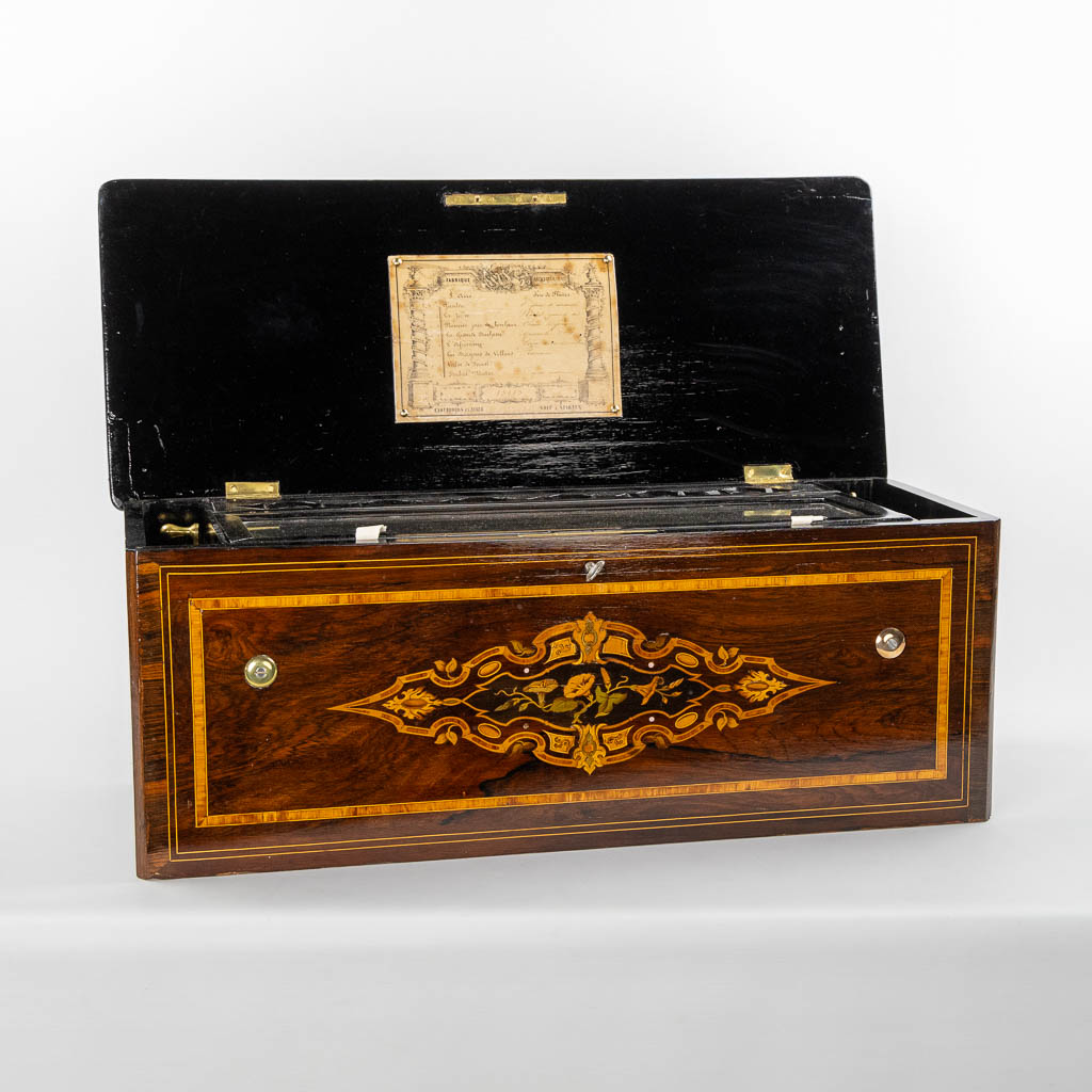 A large music box with an internal organ, in a marquetry inlay box. (L:30 x W:71 x H:27 cm)