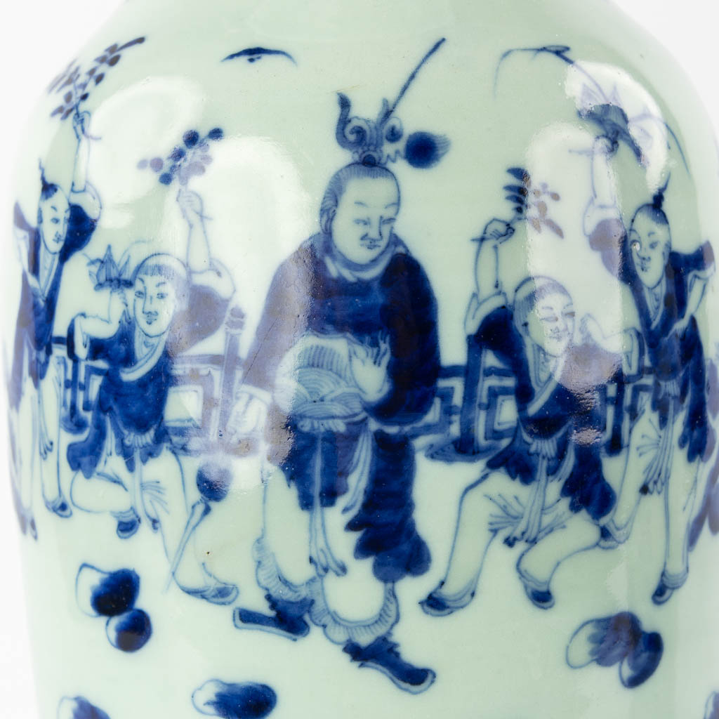 A pair of Chinese vases with a blue-white decor of playing children. (H:57,5 x D:21 cm)