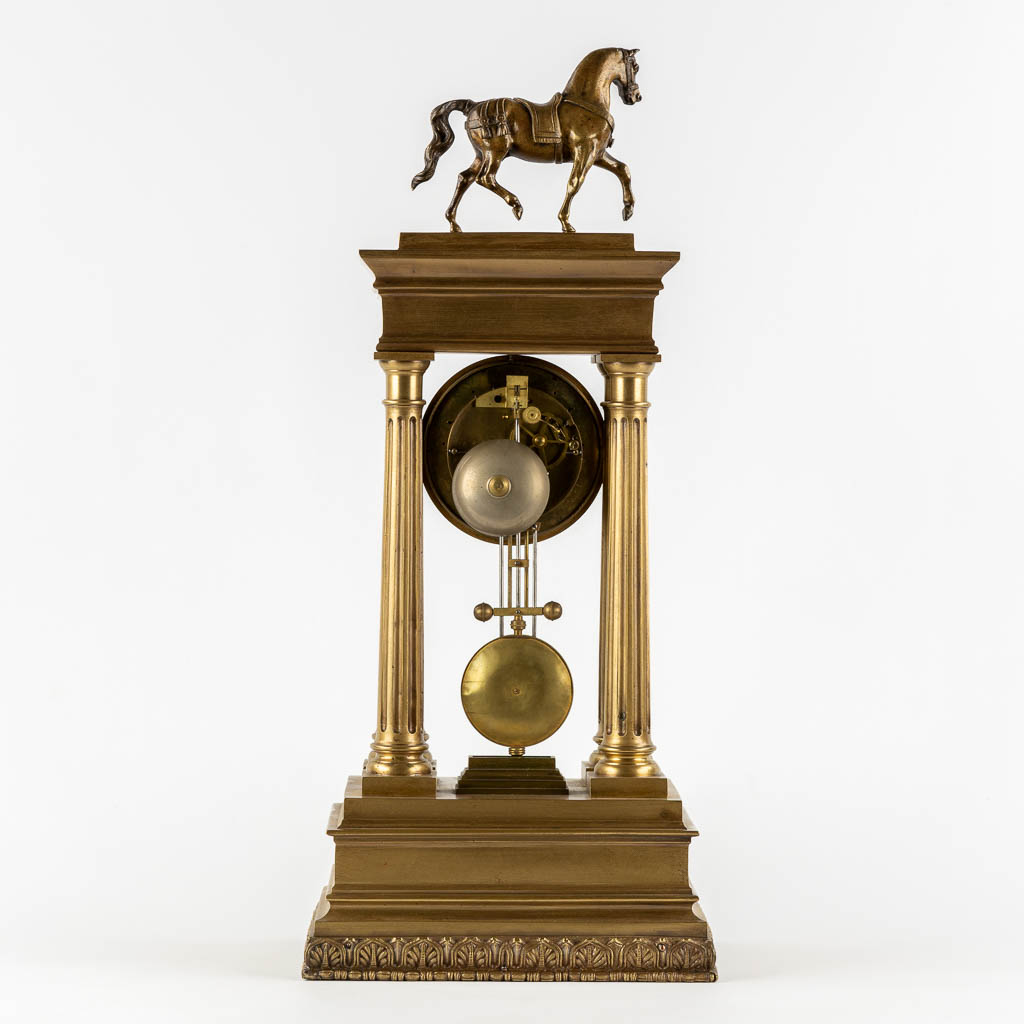 An antique column clock, bronze with a horse figurine. 19th C. (L:18 x W:27 x H:62 cm)