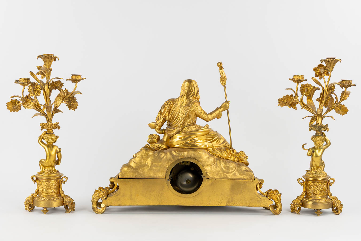 A three-piece mantle garniture clock and candelabra, gilt bronze and Sèvres porcelain, 19th C. (L:20 x W:53 x H:52 cm)