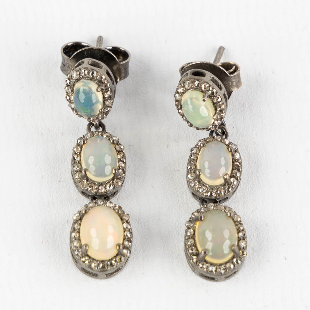 A pair of earrings, silver with opal cabochons and old cut diamonds. (L:3,3 cm)