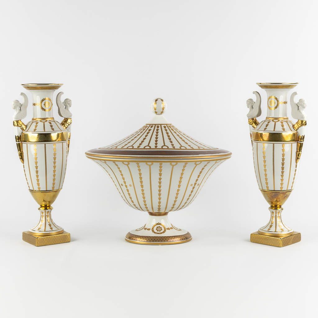 Mangani, Italy, a three-piece garniture, gilt porcelain in Empire style. (L:32 x W:43 x H:40 cm)