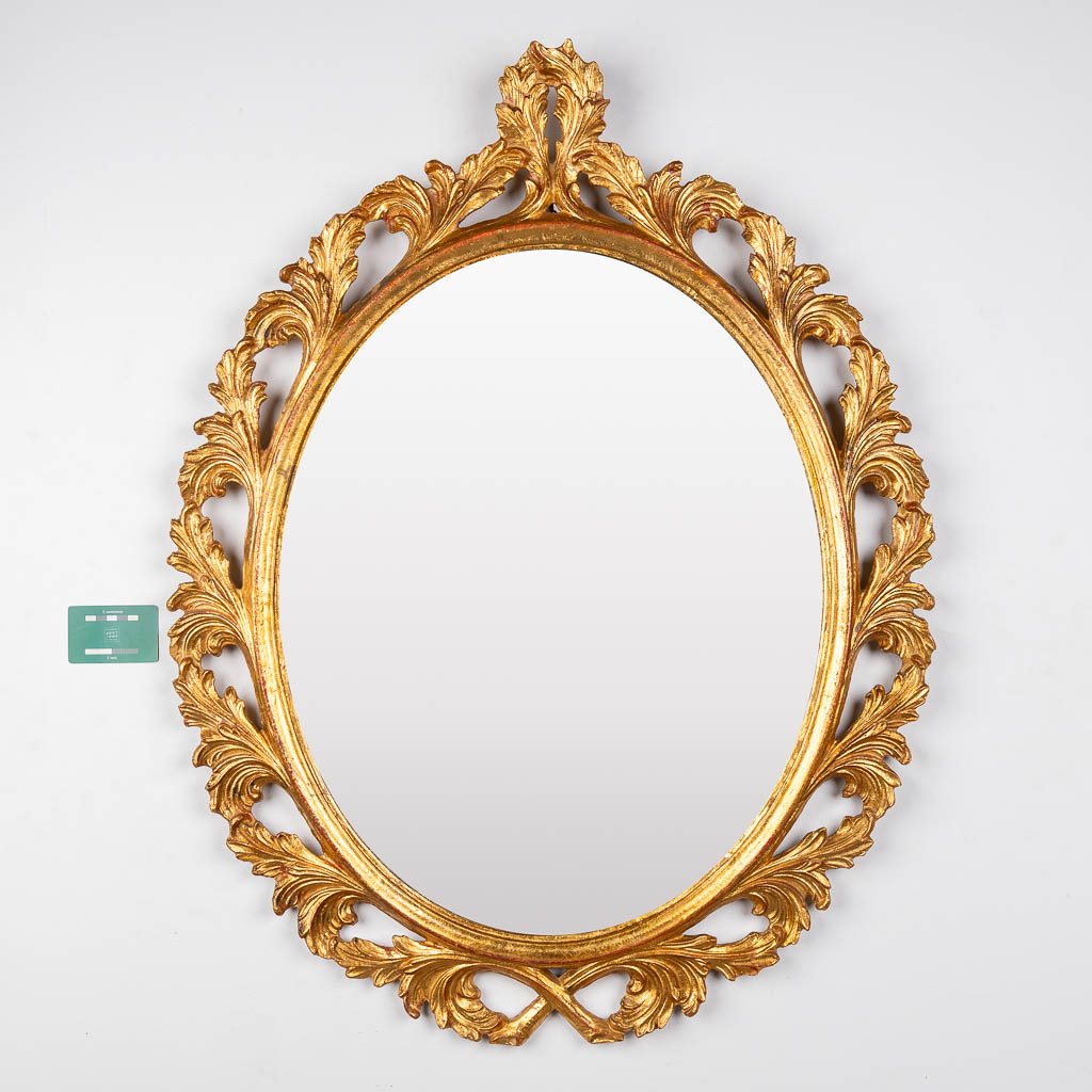 A wood-sculptured oval mirror, circa 1960. (W:73 x H:94 cm)