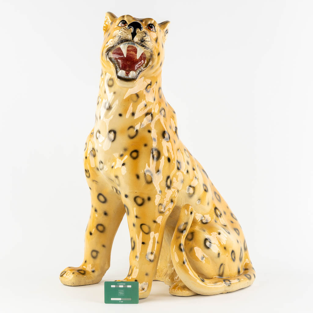 A large glazed faience Leopard, Italy, 20th C. (L:33 x W:46 x H:73 cm)