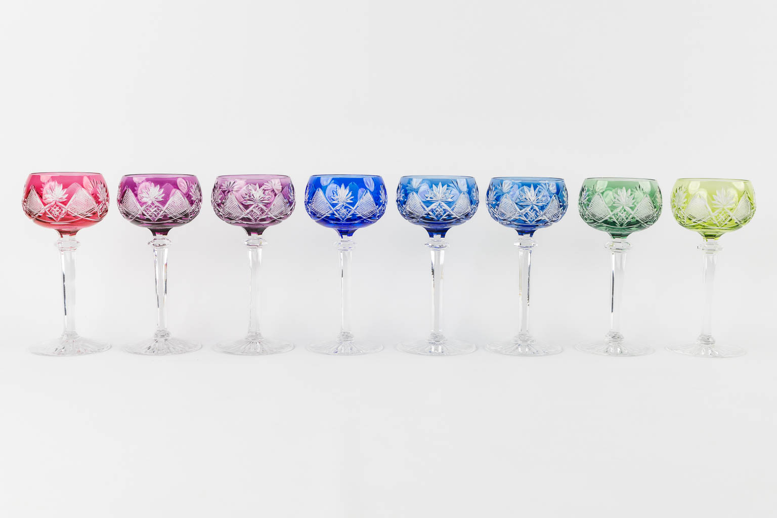 Val Saint Lambert, 36 coloured goblets and two carafes. 