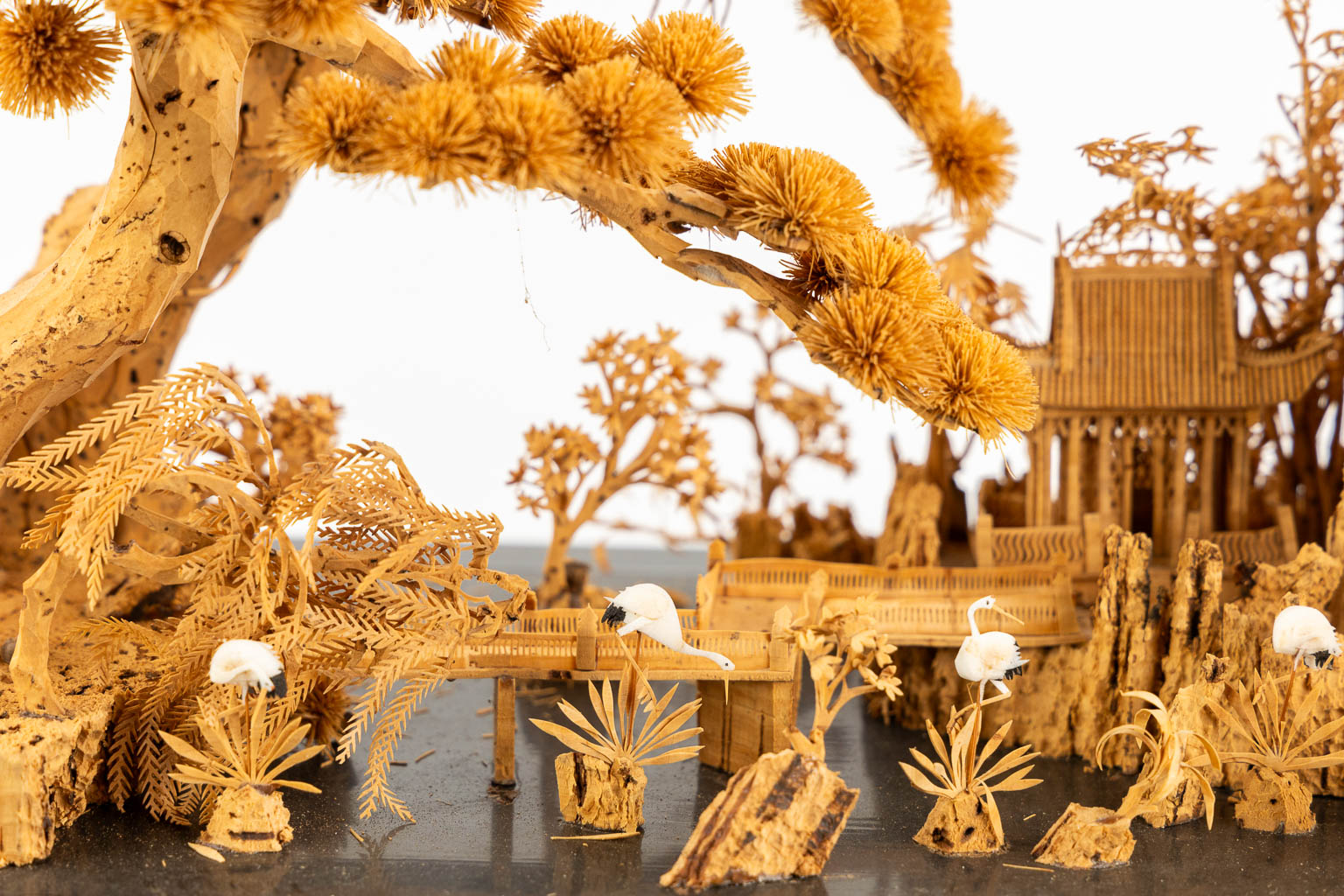 A Japanese cork diorama of a garden, in a glass display cabinet. 20th C. (L:25 x W:55 x H:36 cm)