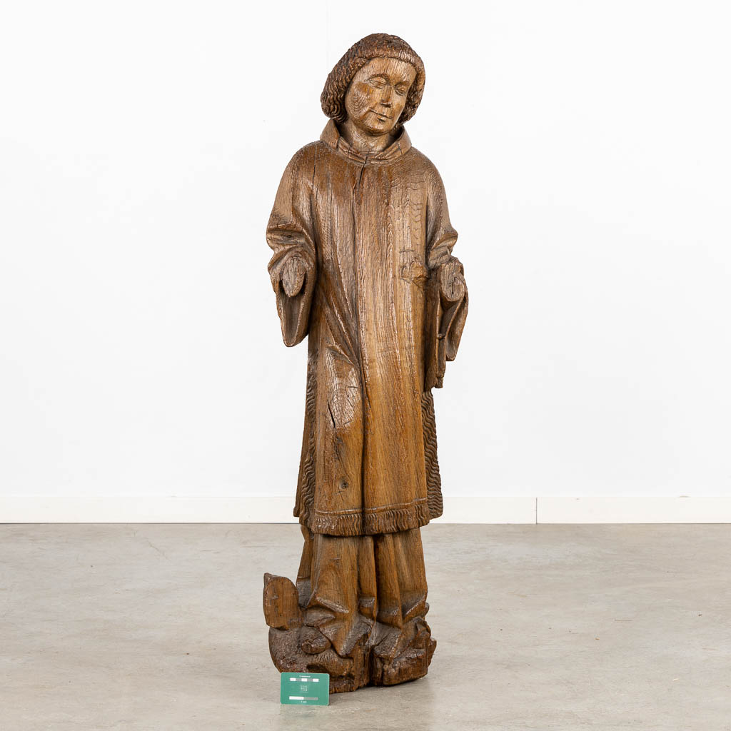 An antique, wood-sculptured figurine of Dacon Laurentius, Gothic, circa 1400. (L:22 x W:36 x H:117 cm)