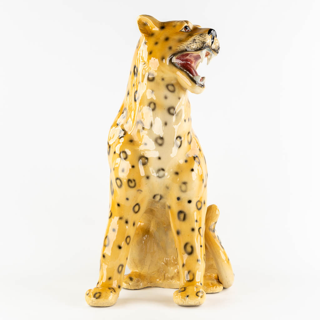 A large glazed faience Leopard, Italy, 20th C. (L:33 x W:46 x H:73 cm)